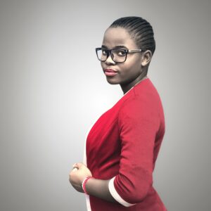 A Black businesswoman wearing red business attire and glasses