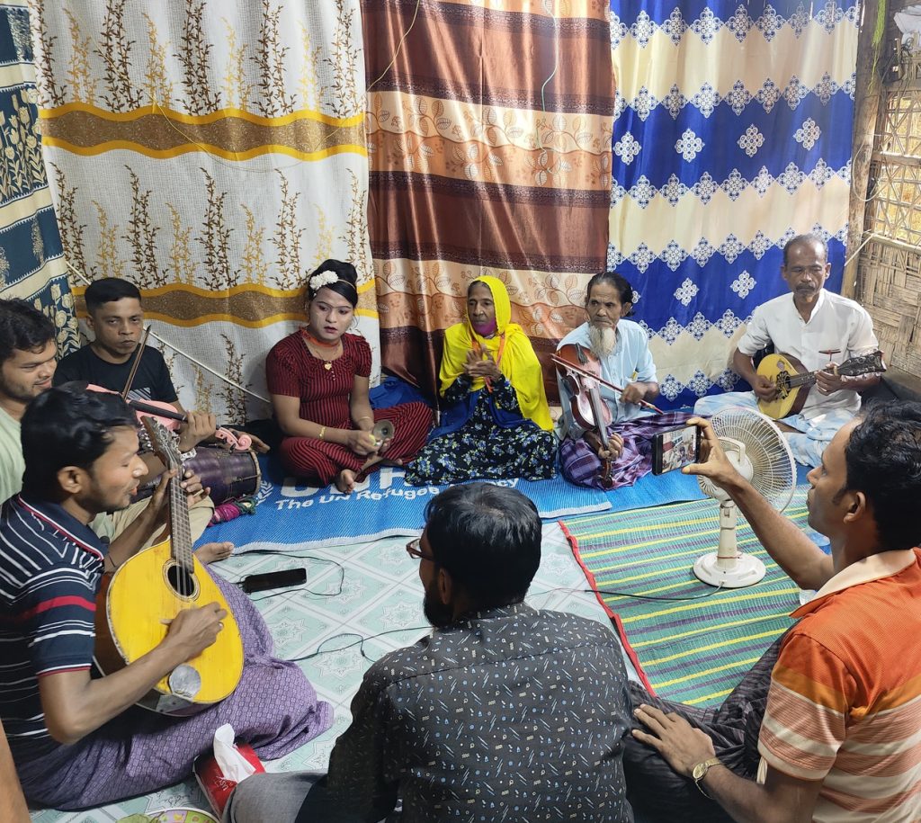 Rohingya people sitting in music circle